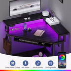Escritorio esquinero pequeño Greenstell para computadora con toma de corriente, escritorio para computadora con luz LED, soporte para monitor, bandeja para teclado y soporte para auriculares